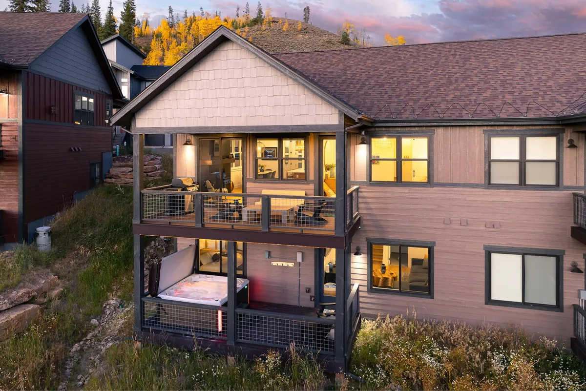 This shot shows a cozy balcony seating area with large windows overlooking a scenic landscape. The balcony is designed for relaxation and outdoor dining, seamlessly blending the comfort of home with the beauty of the outdoors.